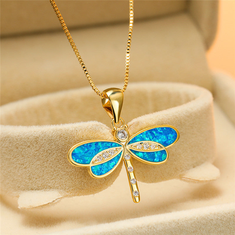 Shimmering opal set in a golden dragonfly women's necklace, nature-inspired fine sterling silver jewelry.