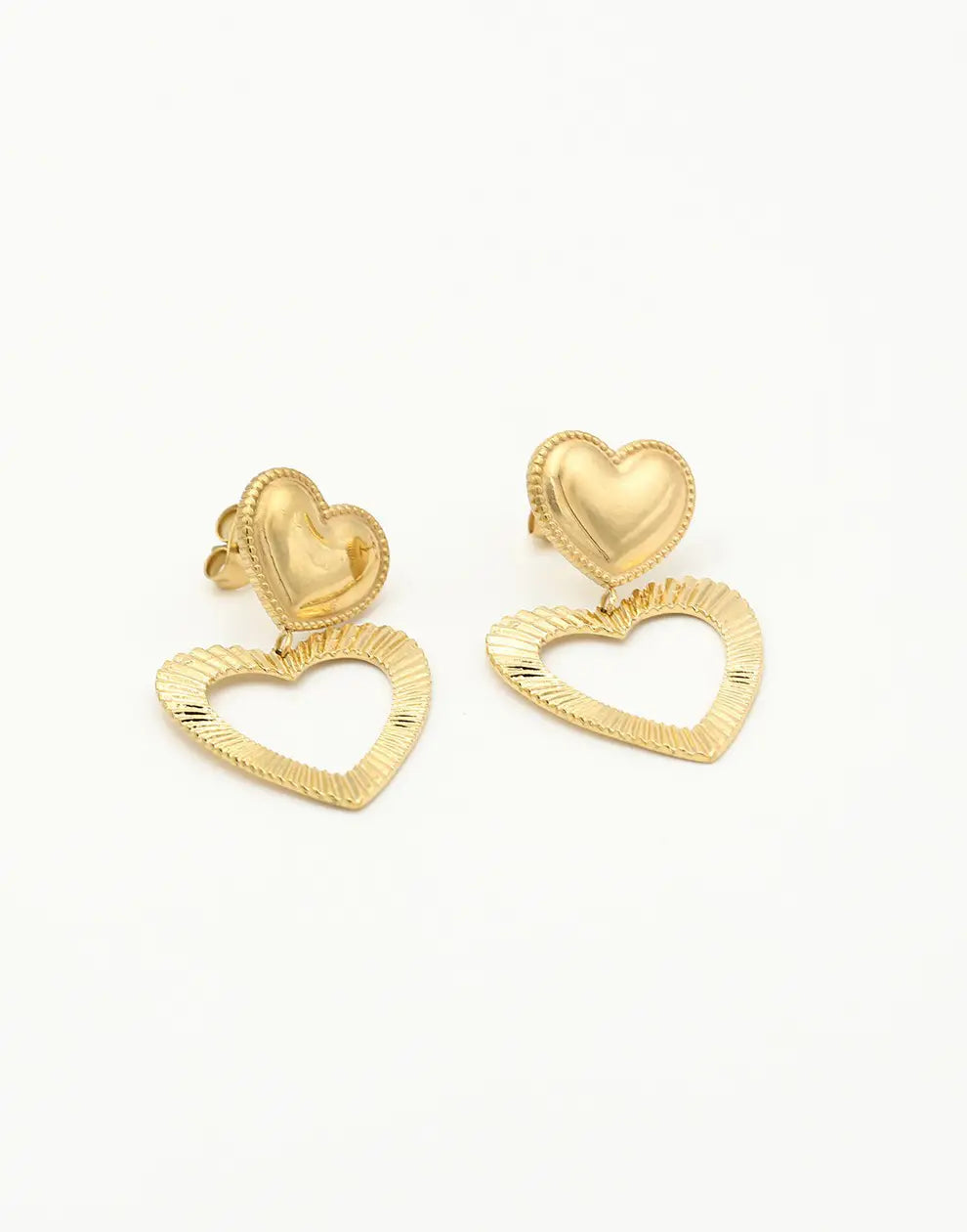 Golden heart stud earrings for women, featuring a delicate and minimalist design. Perfect gold-plated jewelry accessory.