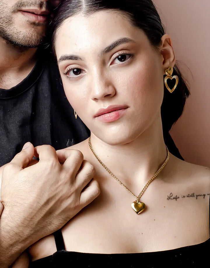 Elegant gold-plated heart stud earrings for women. Delicate fashion accessory, ideal for a minimalist jewelry look.