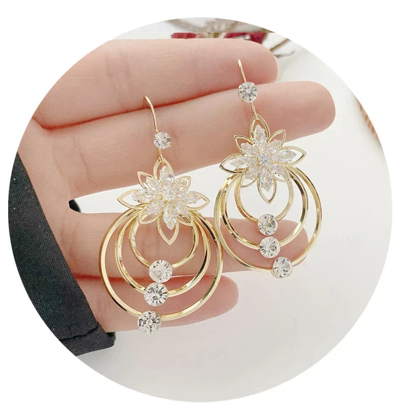 Golden hoop earrings for women, dazzling & elegant jewelry accessory.