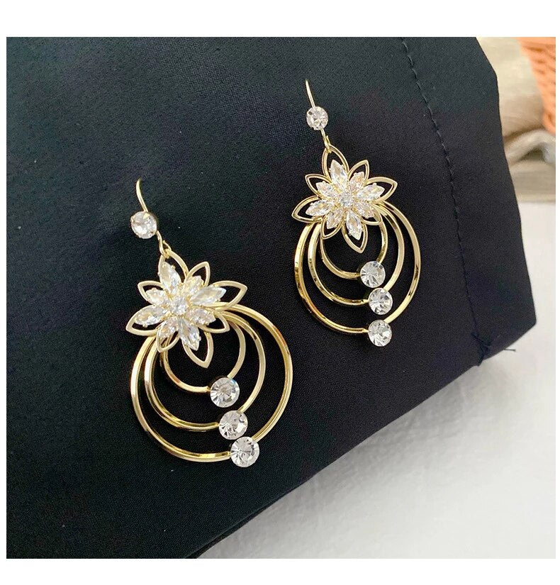 Luxurious gold plated hoop earrings with shimmering crystal accents.