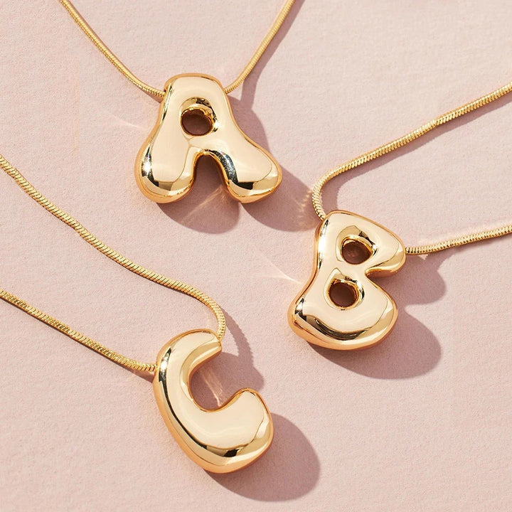 Elegant gold stainless steel initial letter pendant necklace, perfect personalized jewelry for women.