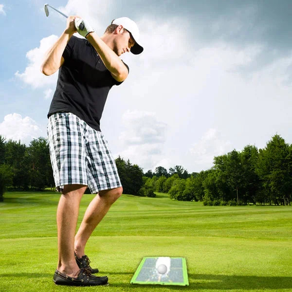 Golfer using a swing analysis mat to detect divot patterns & correct their golf swing for better performance.