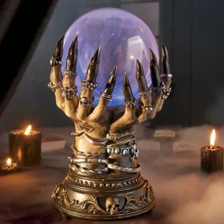 Close-up of a resin gothic skeletal hand base of a plasma lamp, showcasing intricate details.