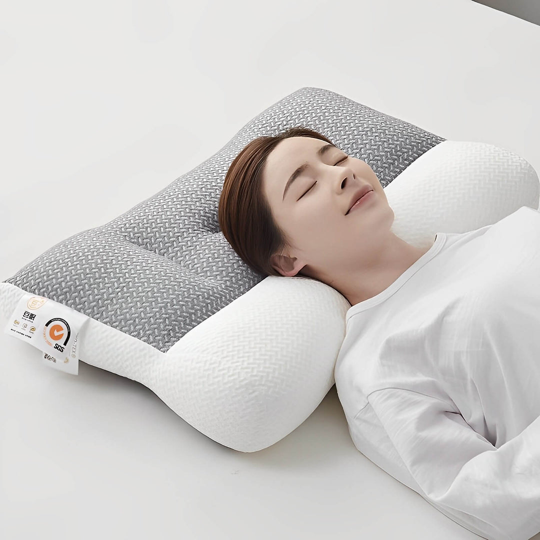 Soft gray ergonomic neck support cushion. Memory foam pillow for orthopedic comfort, restful sleep, and pain relief.