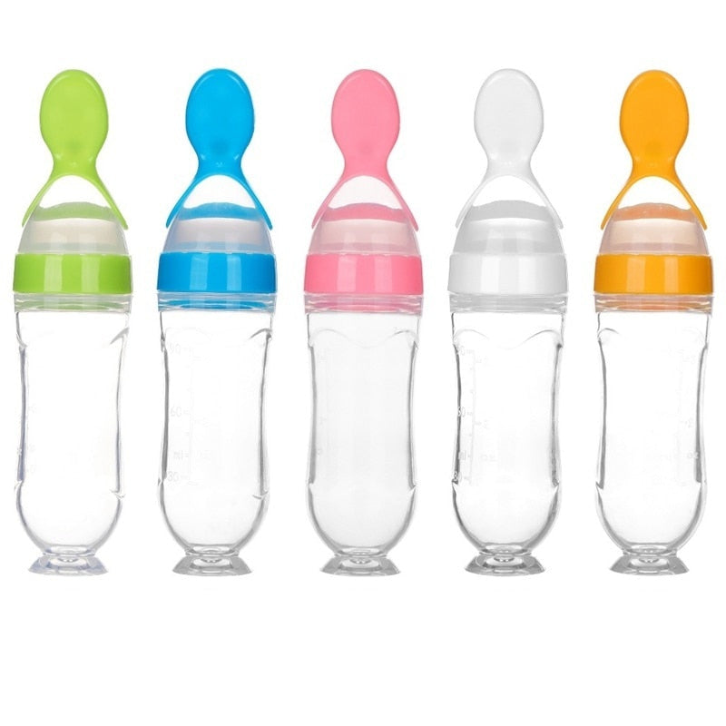 Green baby feeding spoon bottle with soft silicone for mess-free puree dispensing.