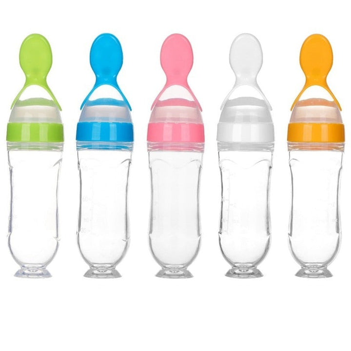 Green baby feeding spoon bottle with soft silicone for mess-free puree dispensing.