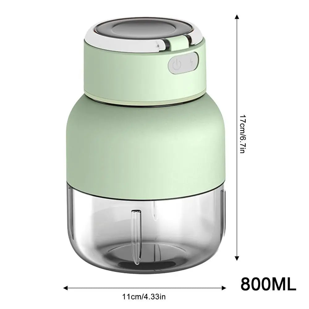 Pink portable blender and juicer, showing it blending a fresh fruit smoothie. Healthy, on-the-go drink maker.