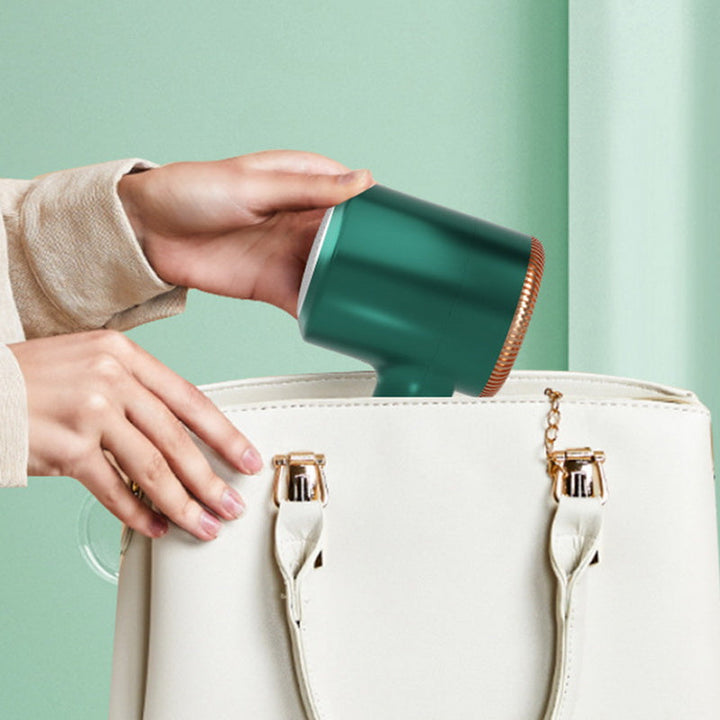 Keep clothes fresh with this green USB rechargeable lint remover, a portable fuzz remover.