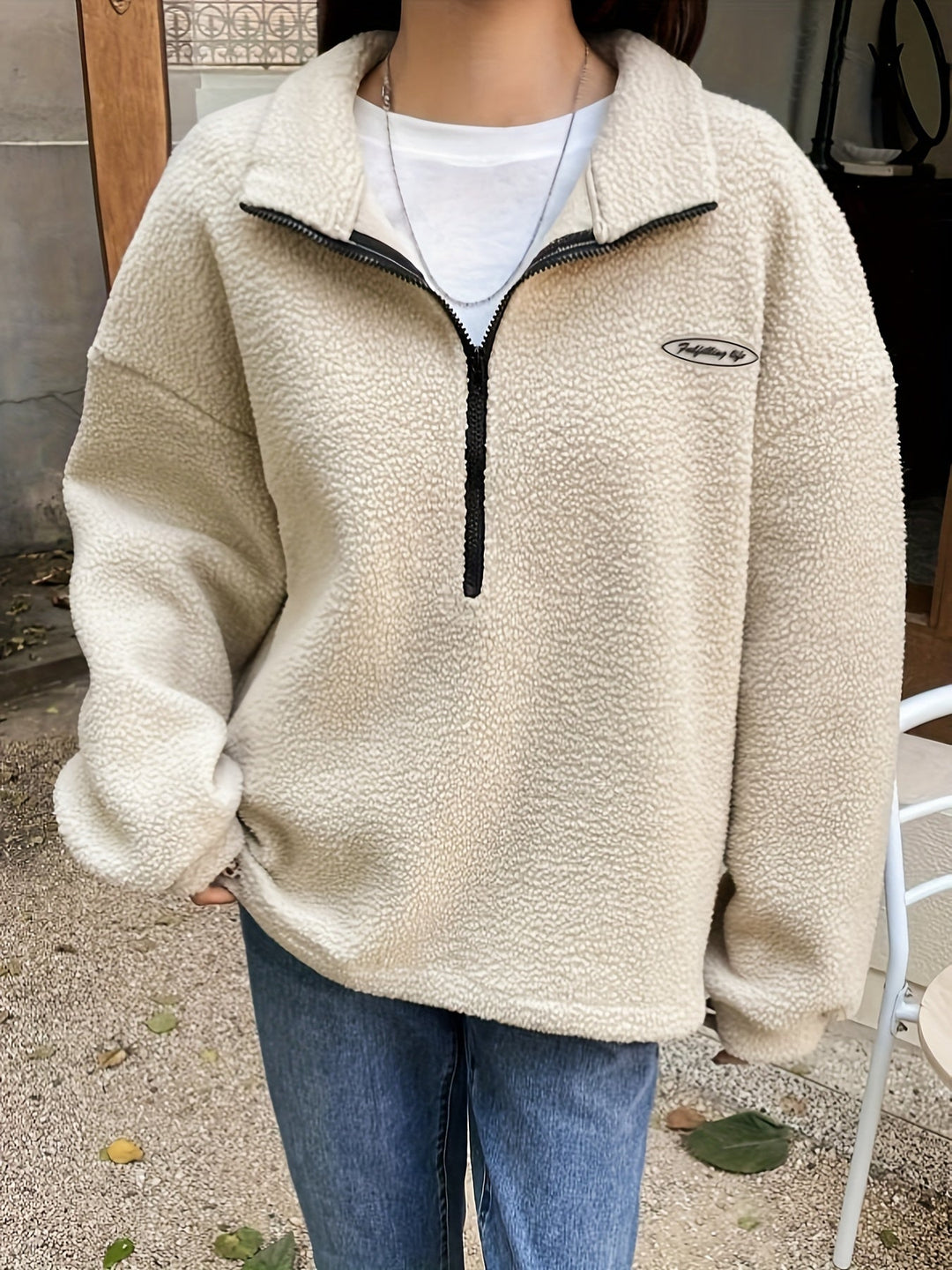 Stylish green women's pullover sweatshirt with a functional quarter-zip neck, perfect for casual outings.