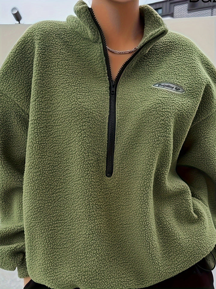 Comfortable beige women's zippered pullover sweatshirt, a versatile long-sleeve top for cooler days.