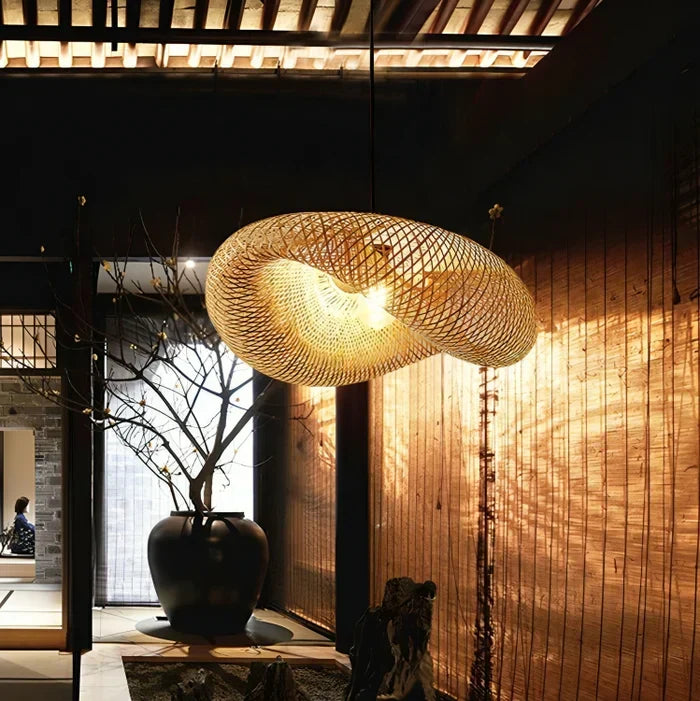 Organic dome-shaped hand-woven rattan pendant lamp. Natural ceiling light fixture for sustainable & modern interiors.