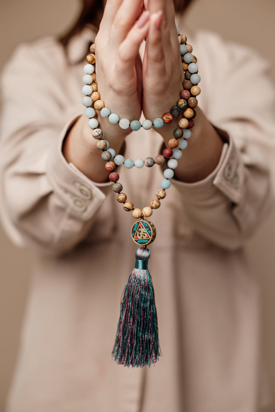 Close-up of Unisex Anaya Aum Mala necklace. Handcrafted with Amazonite & Jasper beads, ideal for meditation.
