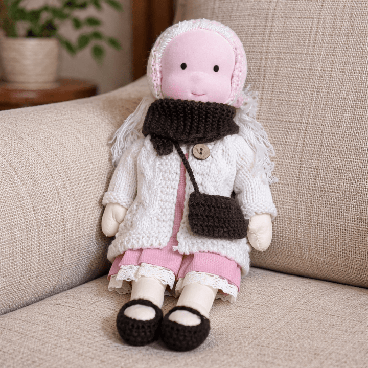 Charming handmade cotton Waldorf doll, a timeless soft toy for creative kids.