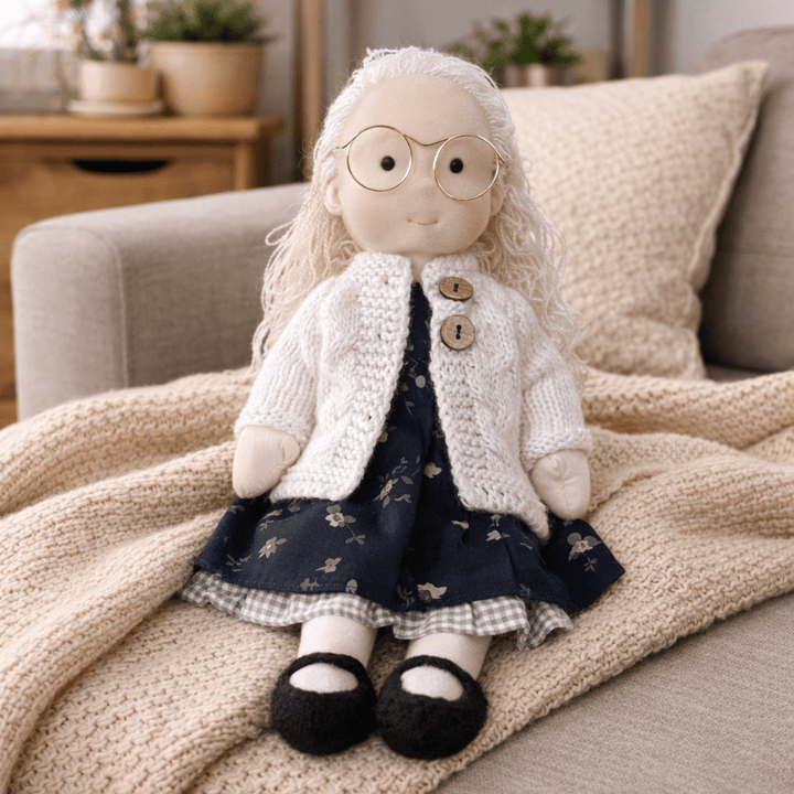 Close-up of a handmade cotton Waldorf doll, ready for imaginative play & cuddles.