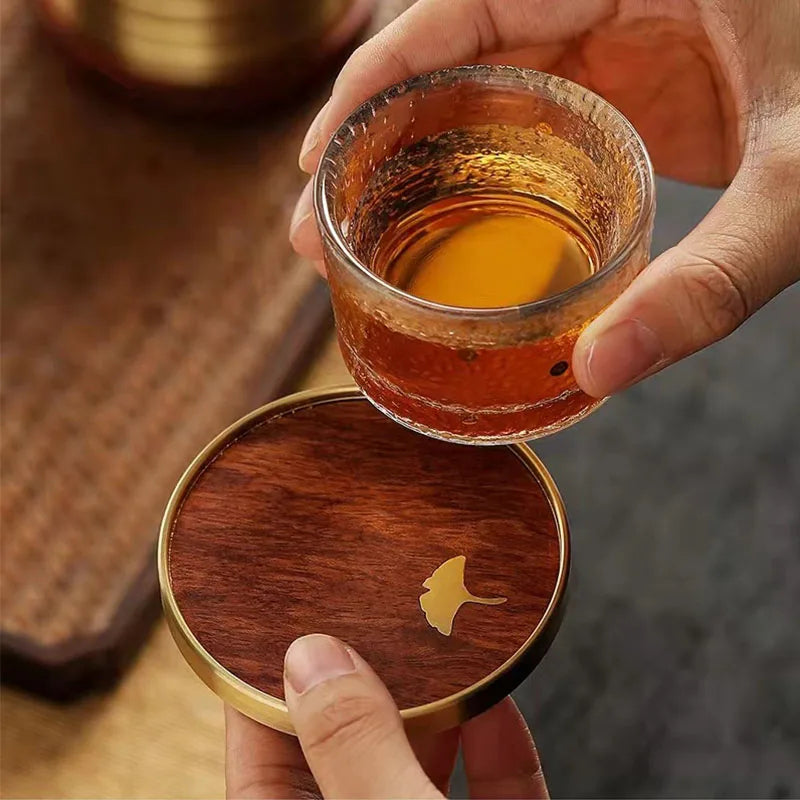 Set of rosewood ginkgo leaf drink coasters, perfect for stylish table protection.