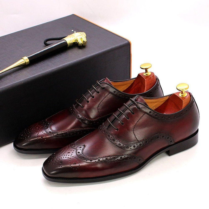 Handcrafted men's brown leather wingtip oxford dress shoes for formal events & business attire, featuring brogue detailing.
