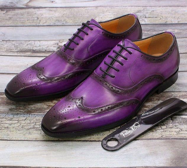 Close-up of men's handcrafted leather wingtip oxford shoes, showcasing fine brogue perforations & elegant design.