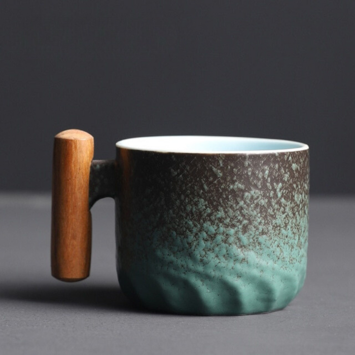 Unique Mini Retrograde handcrafted ceramic tea cup with an elegant retro design and natural wooden handle.