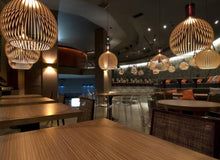 Natural wood pendant lamp, a handcrafted ceiling light bringing warm ambiance to modern homes.