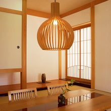 Smooth natural wood pendant lamp, handcrafted finish for a rustic modern home lighting look.