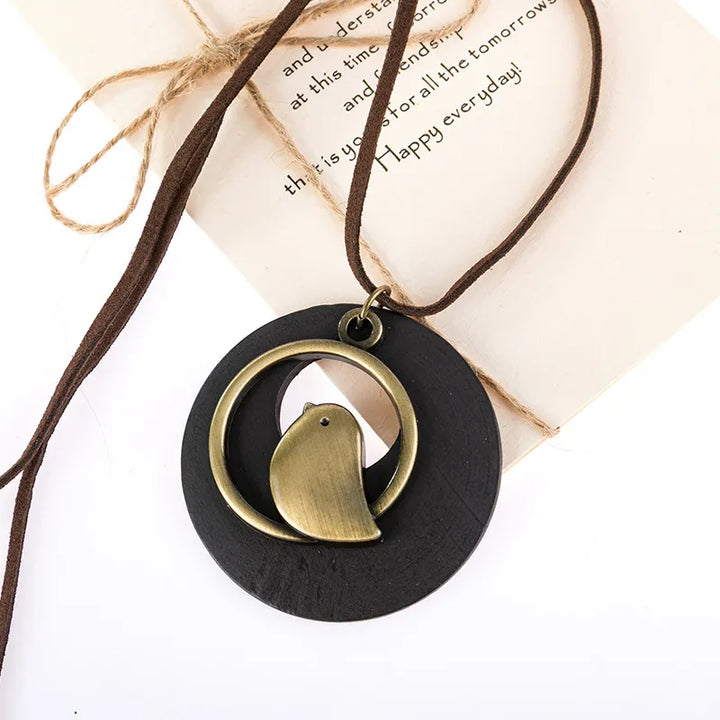 Boho chic women's wooden bird necklace, nature-inspired handcrafted ethnic pendant, stylish gift idea.