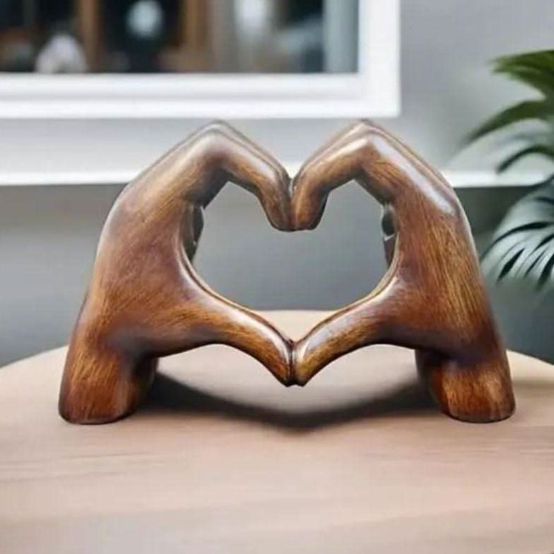 Artisanal wood sculpture of heart hands, a unique decorative figurine for modern home decor.