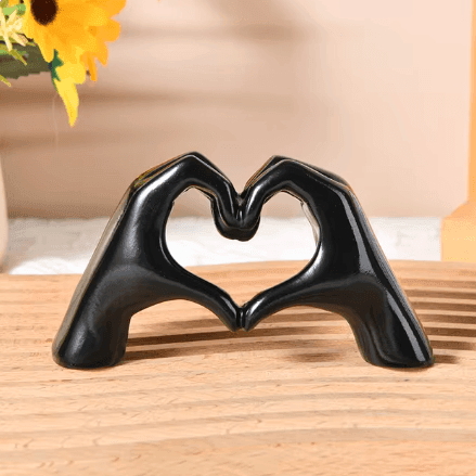 Hand-carved wood heart hands sculpture, a beautiful handcrafted art piece and love symbol for display.
