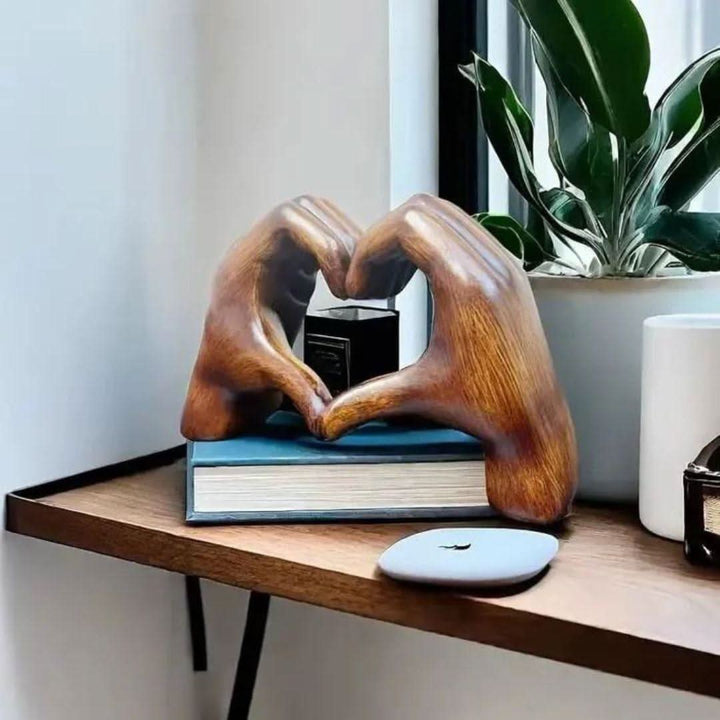 Elegant wood sculpture featuring heart hands, a warm, handcrafted love symbol, perfect for home art.