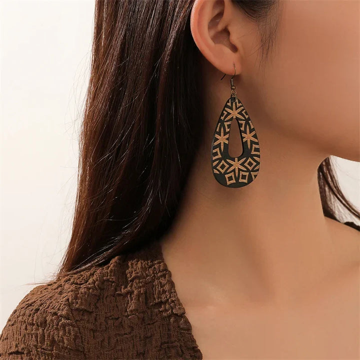Close-up of women's handmade bohemian wood earrings. Lightweight boho style natural wood jewelry for any occasion.