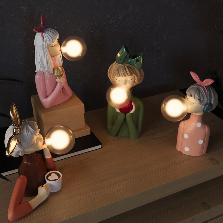 Handcrafted table lamp featuring a vibrant resin base and clear glass shade, providing ambient lighting.