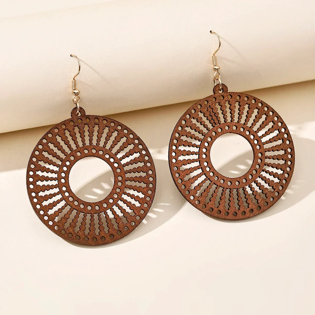 Women's vintage style carved wooden dangle earrings, a unique retro jewelry piece and fashion accessory.