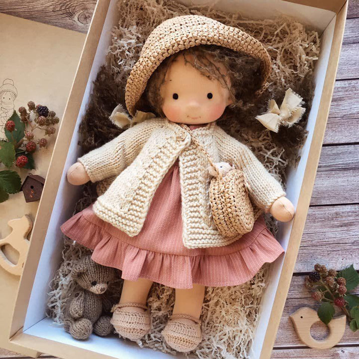 Handmade Waldorf doll Poppi, a unique children's cuddle toy. Crafted from soft, natural materials for lasting play.
