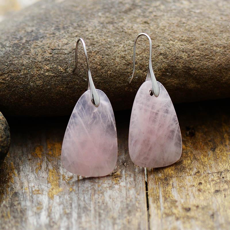 Close-up of Ameline Aura Rose Quartz protection dangle earrings, handmade spiritual healing gemstone.
