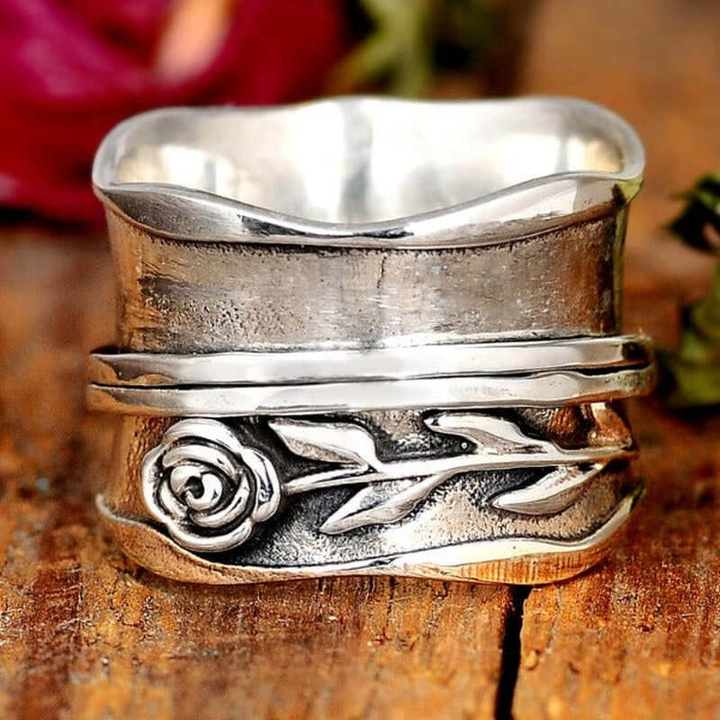 Handmade women's sterling silver flower ring with intricate lilac floral design. A stylish and unique jewelry accessory.