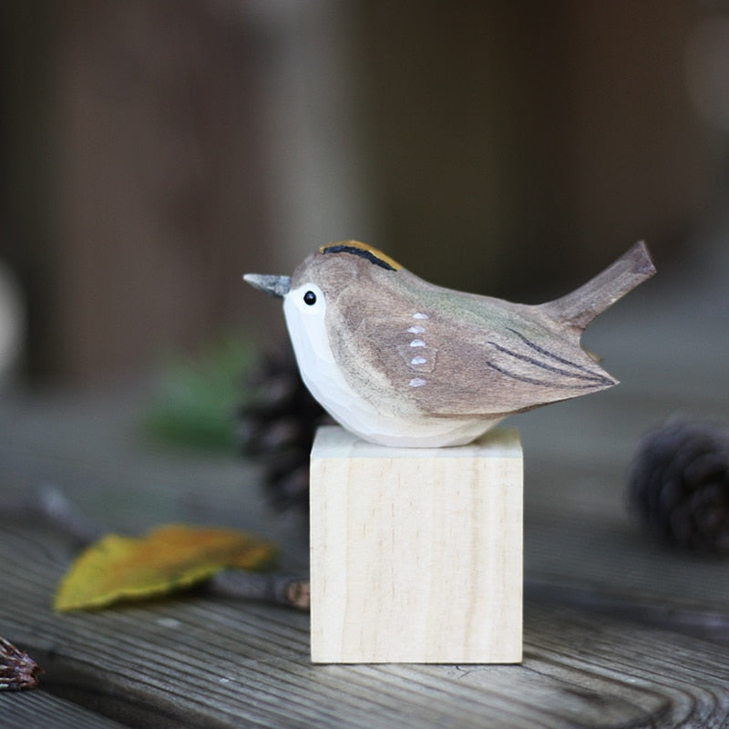 Carved wooden bird figurines in Scandinavian style, elegant wildlife art for home accents.