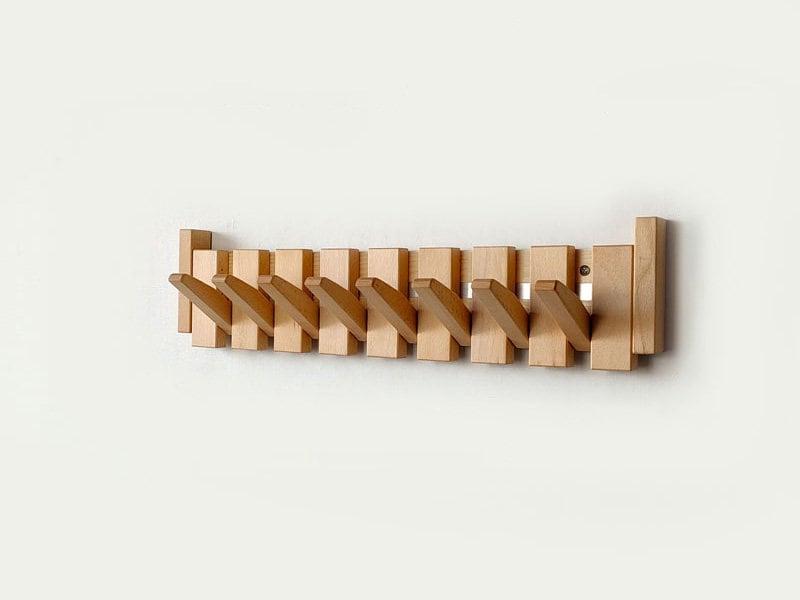 Elegant handmade wooden coat rack. Stylish entryway decor with multiple foldable hooks for coats & accessories.