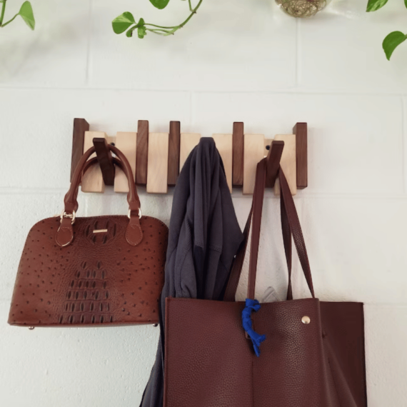 Declutter your entryway with this handmade wooden coat rack. Features practical folding hooks for coats, keys & more.