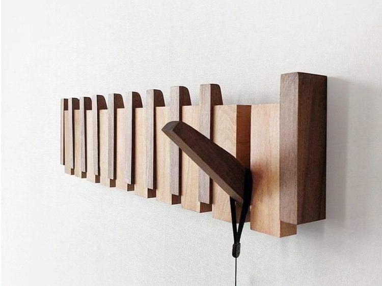 Artisan-crafted wooden coat rack. Versatile wall organizer with sleek foldable hooks, perfect for any hallway decor.