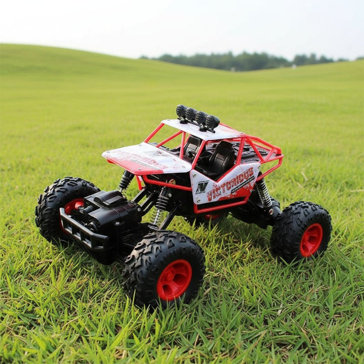 Front view of a powerful 4x4 RC monster truck with bright LED headlights, ready for night offroad racing.