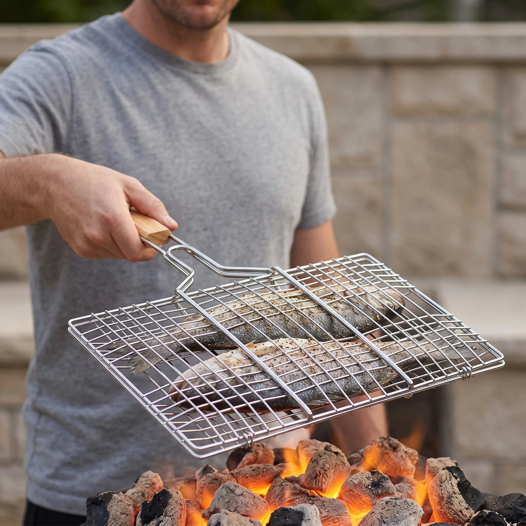 Hinged outdoor grilling basket for BBQ, perfect for easy flipping fish, vegetables, or meats on the grill.