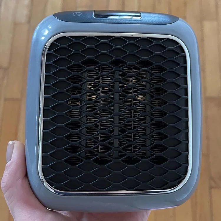 Person placing a Hulvio portable heater, emphasizing its ease of use and compact size