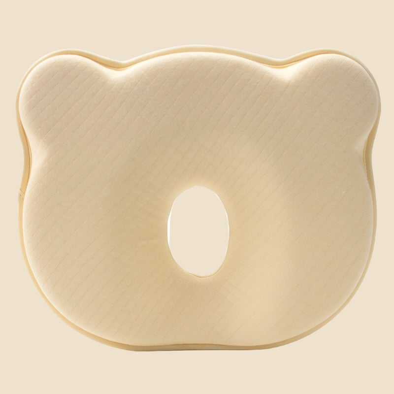 Ergonomic memory foam infant pillow for head support, helps prevent flat spots on baby's head.