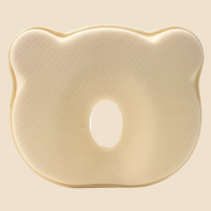 Ergonomic memory foam infant pillow for head support, helps prevent flat spots on baby's head.