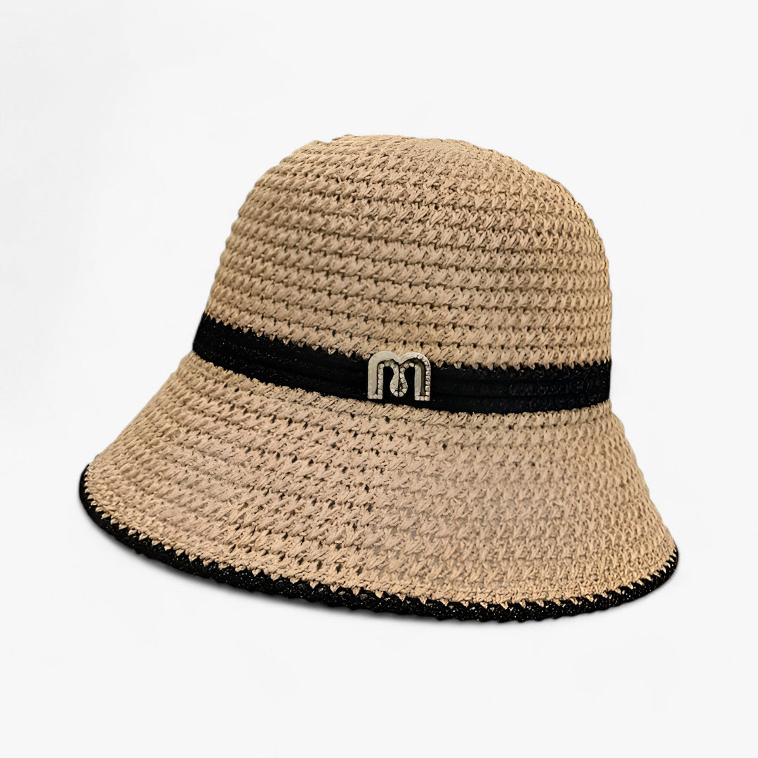 Beige women's wide brim beach hat, perfect summer accessory for sun protection and travel.