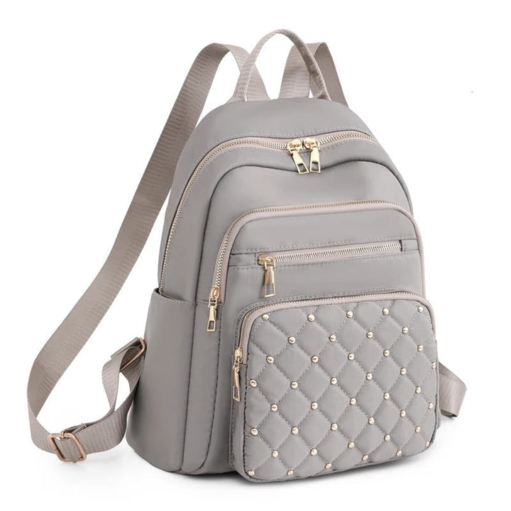 Black lightweight water-resistant nylon backpack for women, ideal for commuting and school.