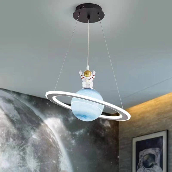 Whimsical cosmic planet LED pendant light. Inspires imagination in kids' rooms with its space-themed galaxy glow.