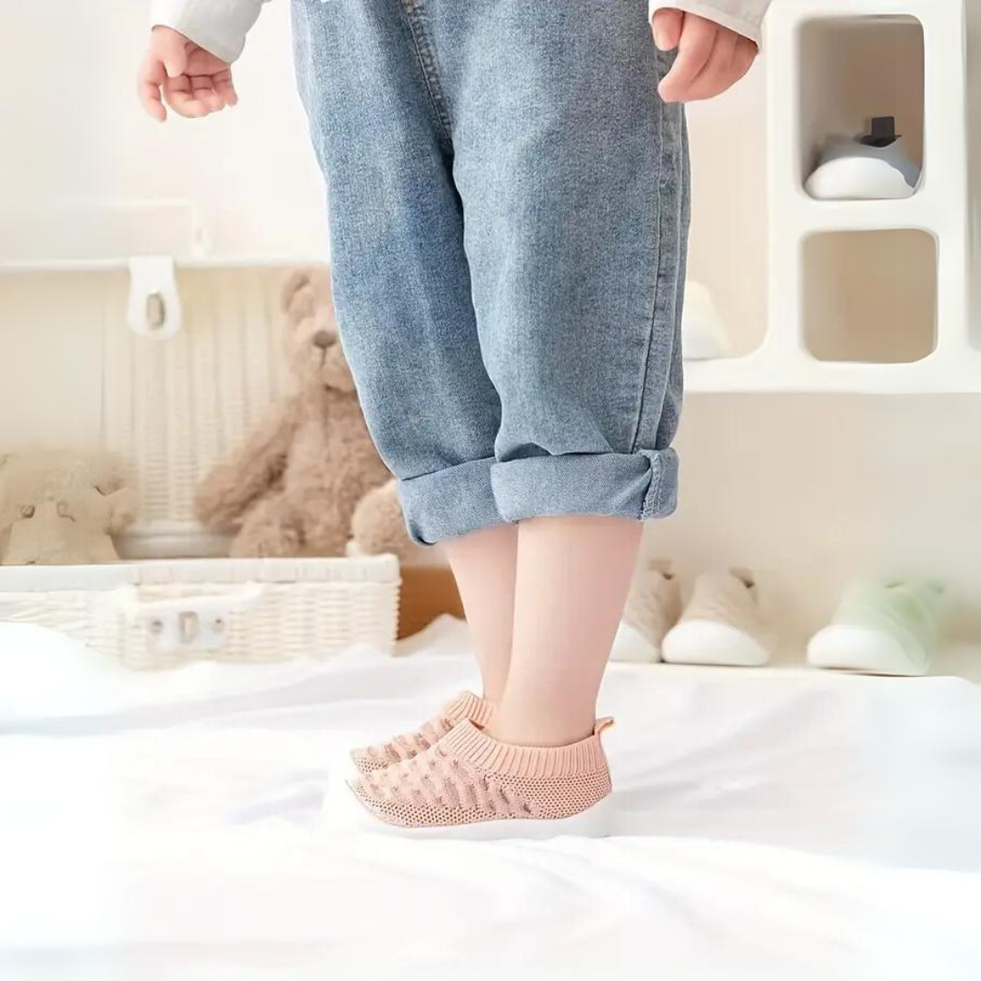 Soft baby FlexiFeet barefoot shoes, flexible & lightweight for developing feet, supporting natural movement.