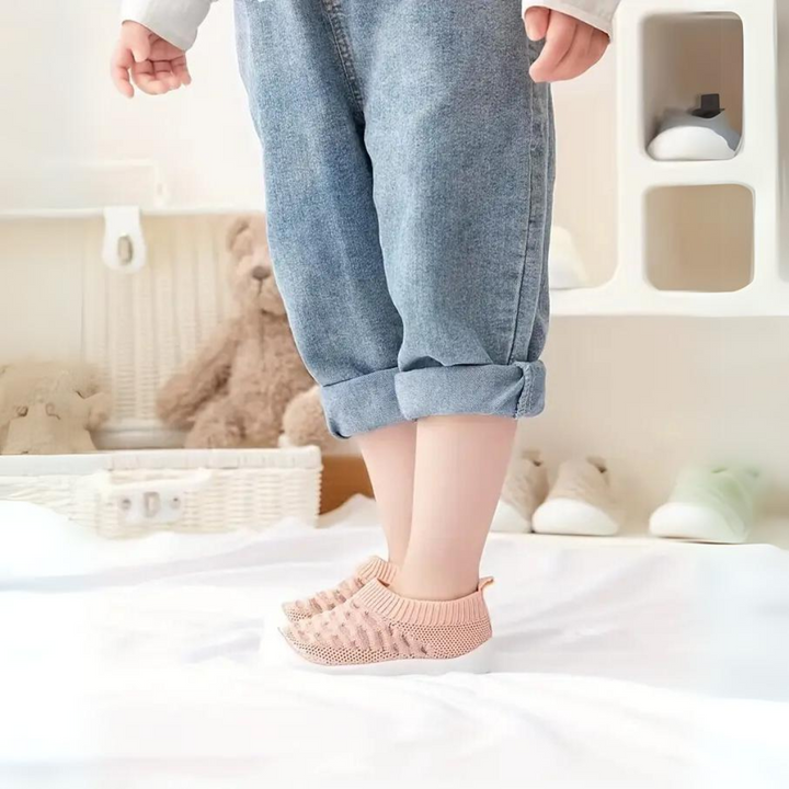 Soft baby FlexiFeet barefoot shoes, flexible & lightweight for developing feet, supporting natural movement.