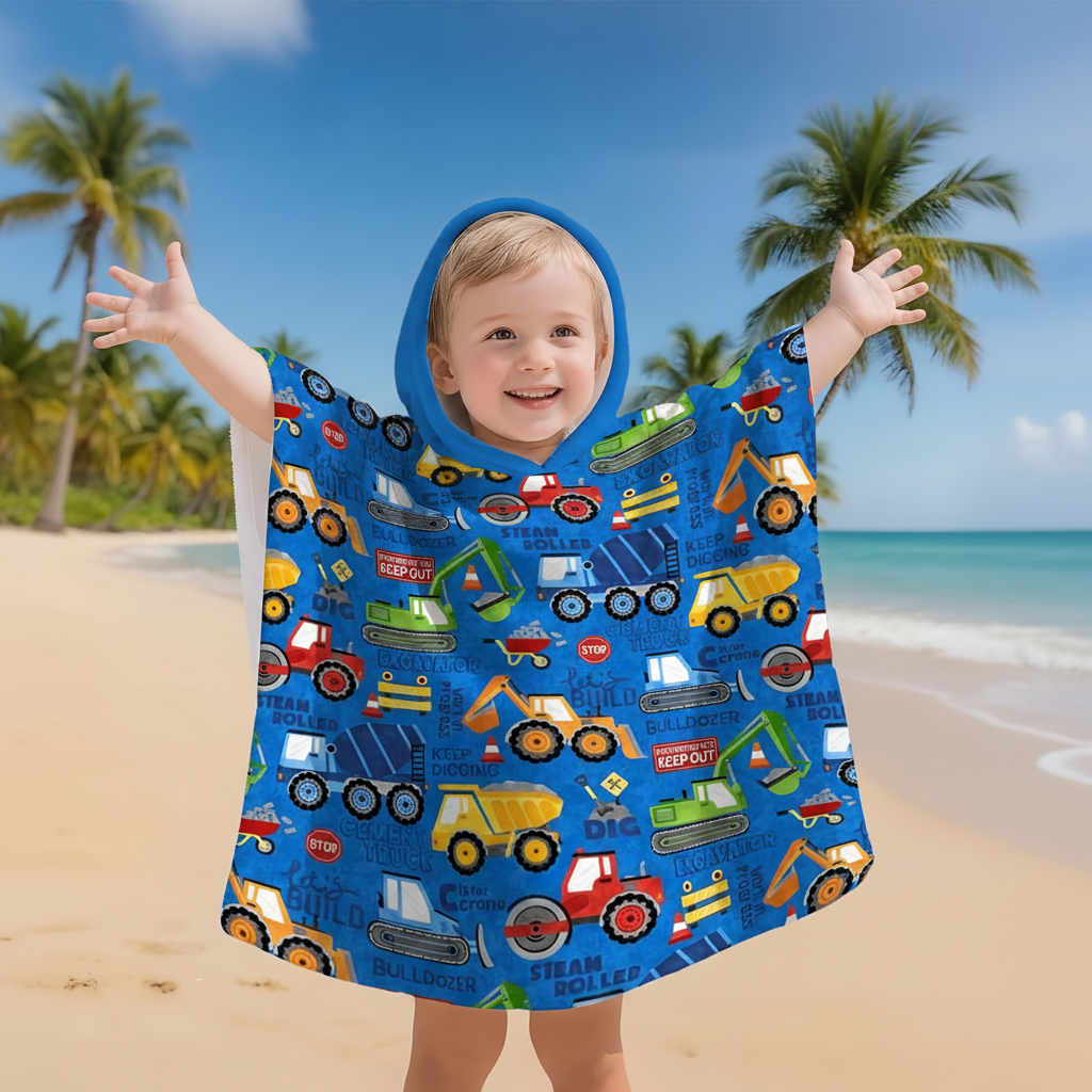Kids' hooded poncho with construction print, perfect for playwear, made from water-repellent polyester.